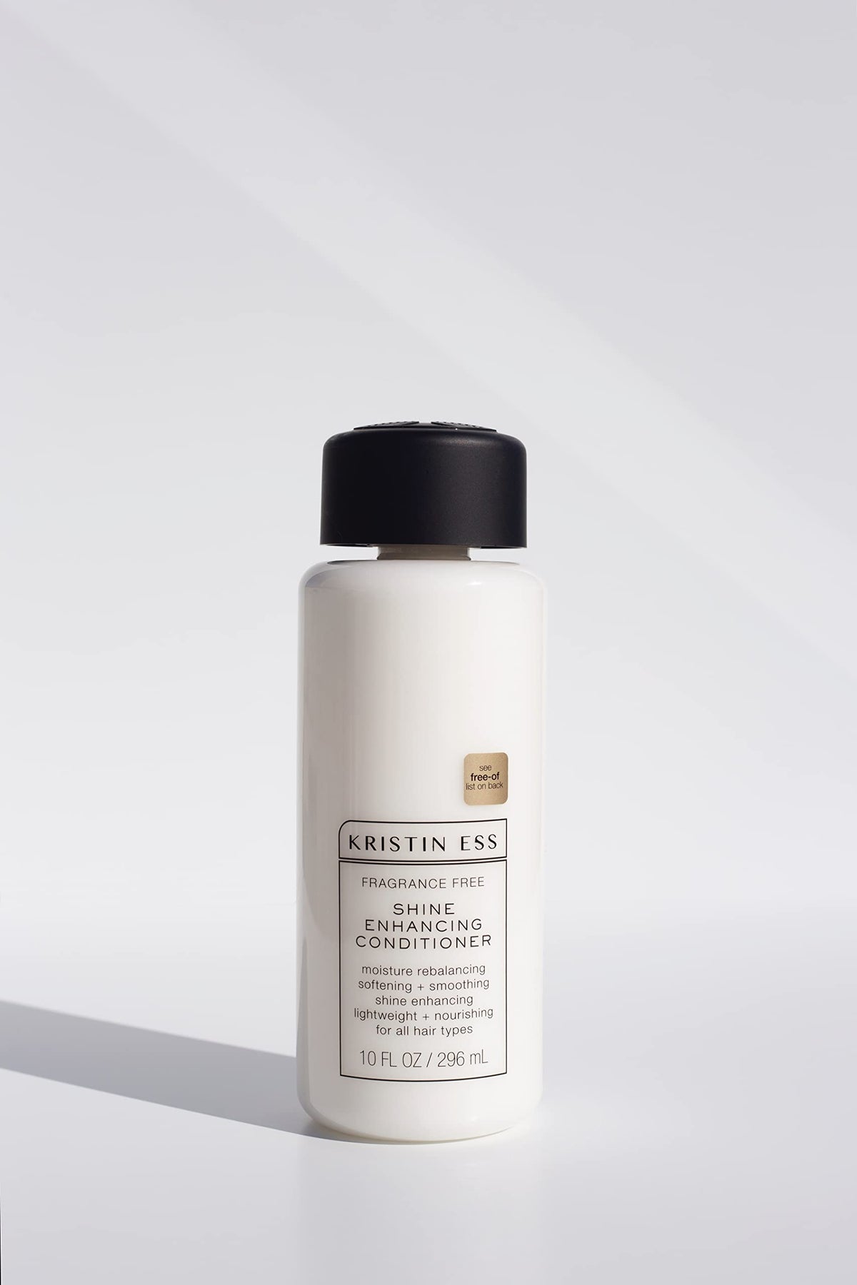 Kristin Ess shampoo texture in hand showing gentle lather and cleansing benefit