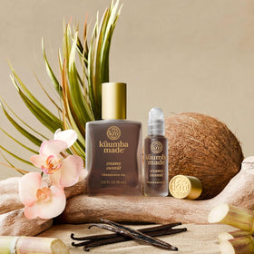 Kuumba Made bottle on vanity with sunlight suggesting warm tropical fragrance