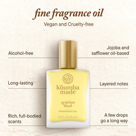 Kuumba Made bottle in hand for scale illustrating compact 0.5 fl oz convenience