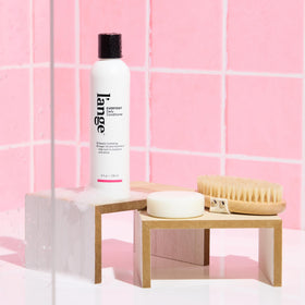 L'ANGE HAIR conditioner on bathroom shelf in lifestyle scene showing routine fit