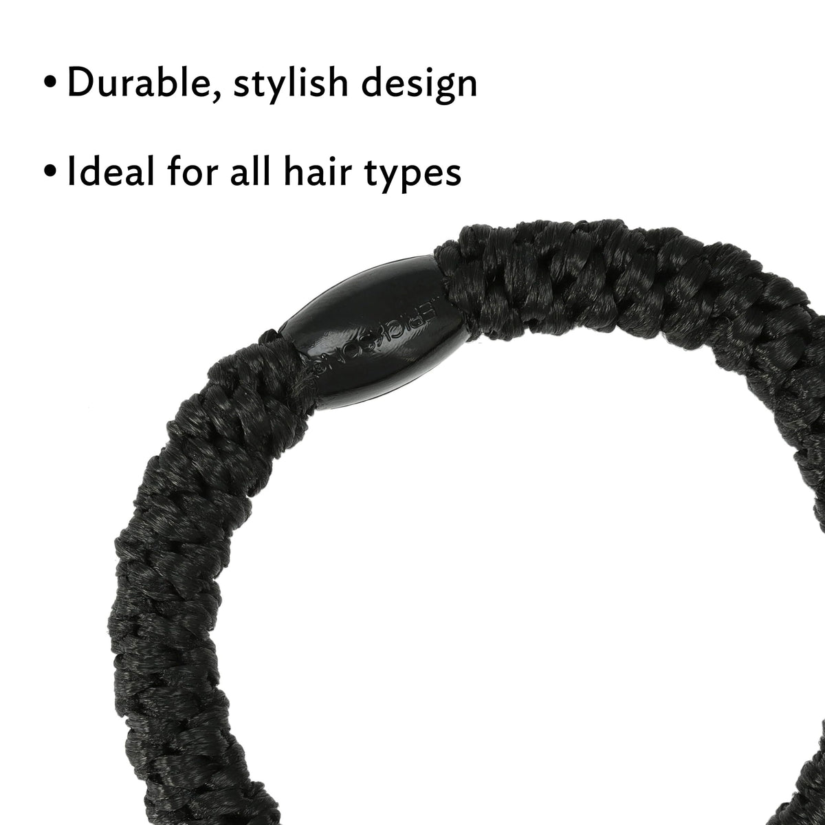 L. Erickson hair tie beside a coin showing 2-inch diameter and travel-ready size