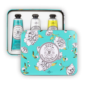 La Chatelaine tin beside a passport to show travel-friendly compact size and convenience