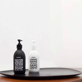 La Compagnie de Provence bottle styled on bathroom shelf, elevates sinkside decor benefit