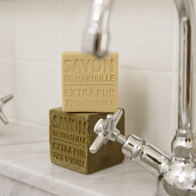 La Compagnie de Provence cube in hand lathering for gentle face and body cleansing, soothing