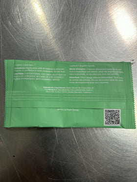 Hand holding LA Fresh wipe showing size and easy portability benefit