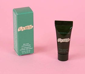 La Mer eye concentrate travel tube in hand demonstrating compact size for travel convenience