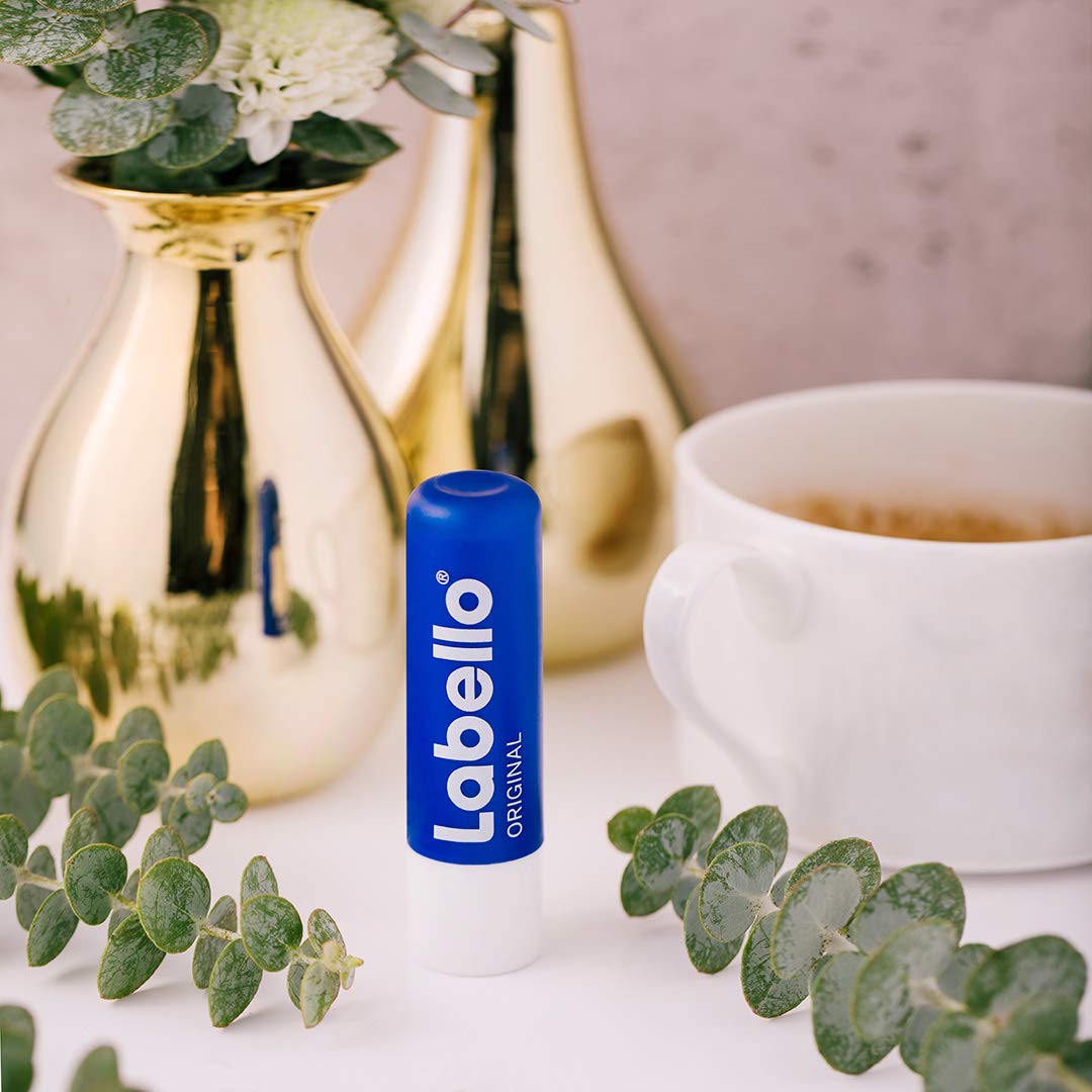 Hand applying Labello balm to lips illustrating quick hydration benefit