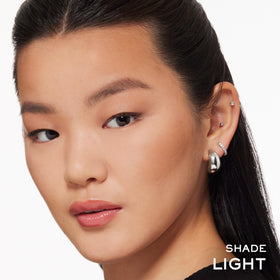 Lancôme bronzer swatch on arm showing natural warm tint for subtle sun-kissed benefit