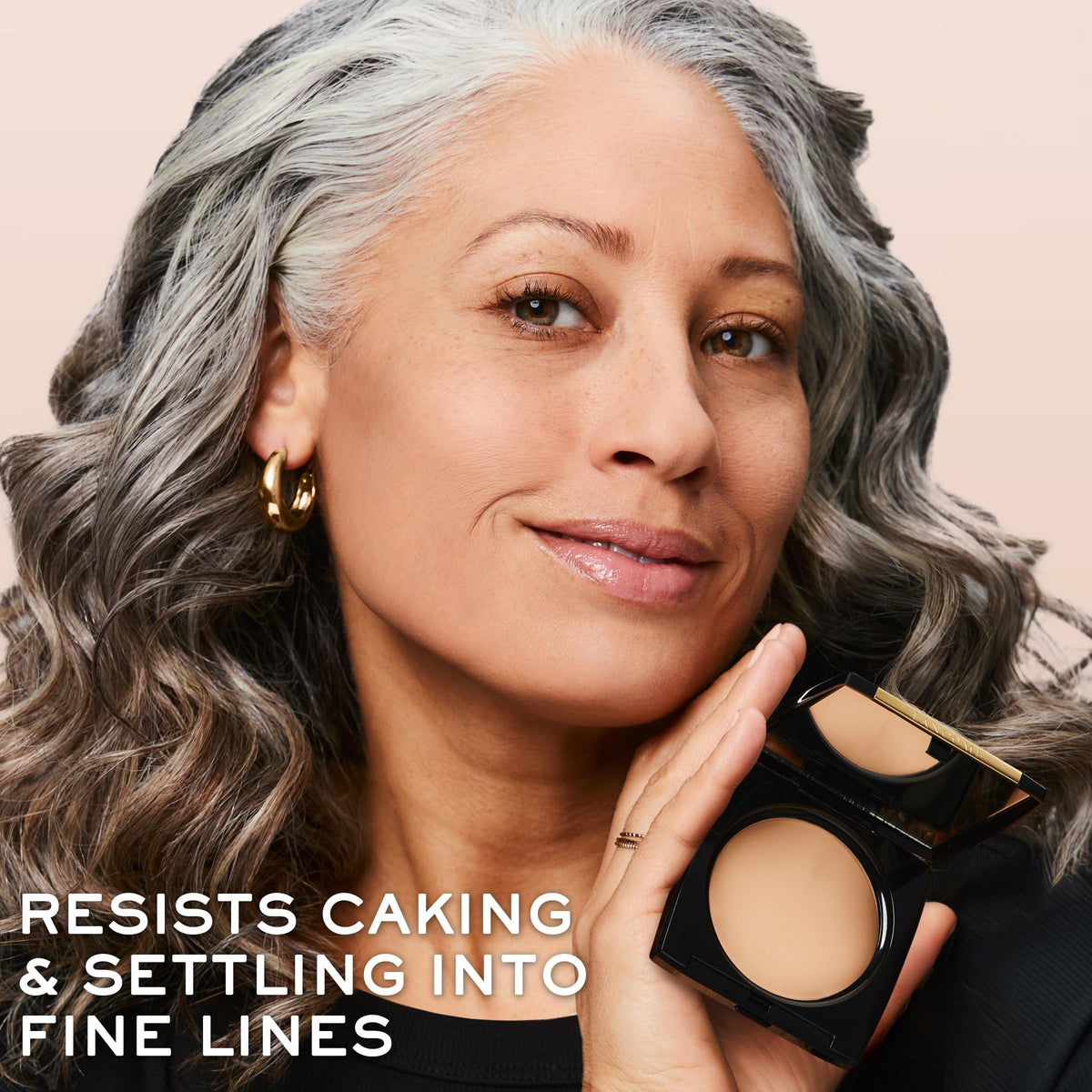 Lancôme compact held in hand showing compact size and portable convenience