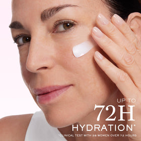 Lancôme set next to a hand to show product scale and convenient travel-friendly sizes