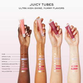 Lancôme Juicy Tubes next to a coin showing compact size and travel convenience