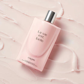 Lancôme applying lotion on arm showing soft hydrated skin benefit