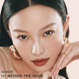Lancôme applying lipstick in mirror illustrating easy everyday use