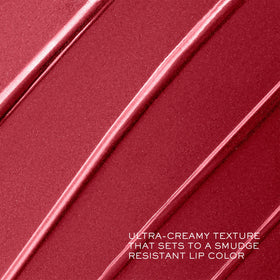 Lancôme lipstick beside coin to show compact size and portability