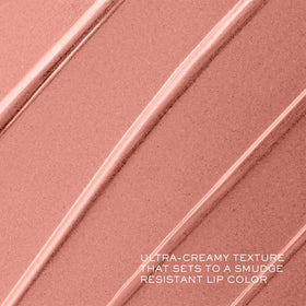 Lancôme tube beside fingers showing compact size and travel-friendly benefit