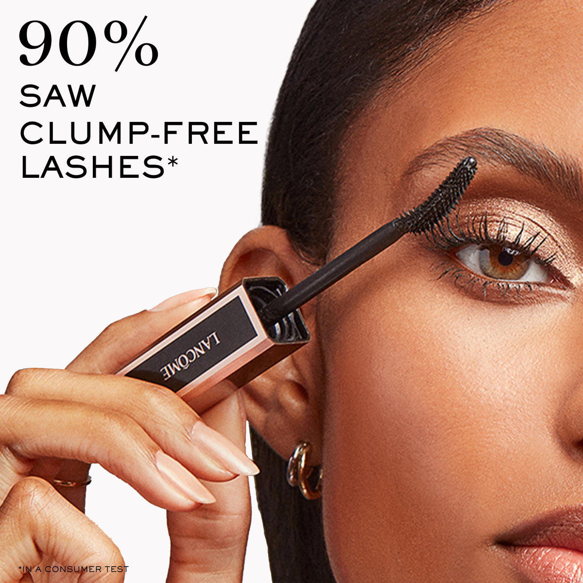 Lancôme Lash Idôle next to a coin to show tube size and portability