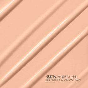 Lancôme lifestyle image of woman applying foundation for effortless glow