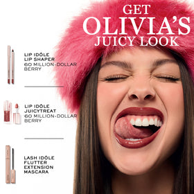 Lancôme lifestyle still of JuicyTreat bottle on reflective surface showing premium finish benefit
