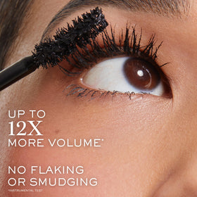 Travel-size Lancôme Monsieur Big tucked inside a purse for on-the-go touch ups
