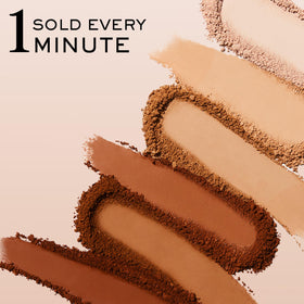 Lancôme compact beside fingers for scale, illustrating travel-size convenience and portability