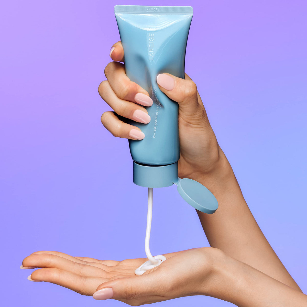 LANEIGE bottle held in hand for size perspective and travel-friendly benefit