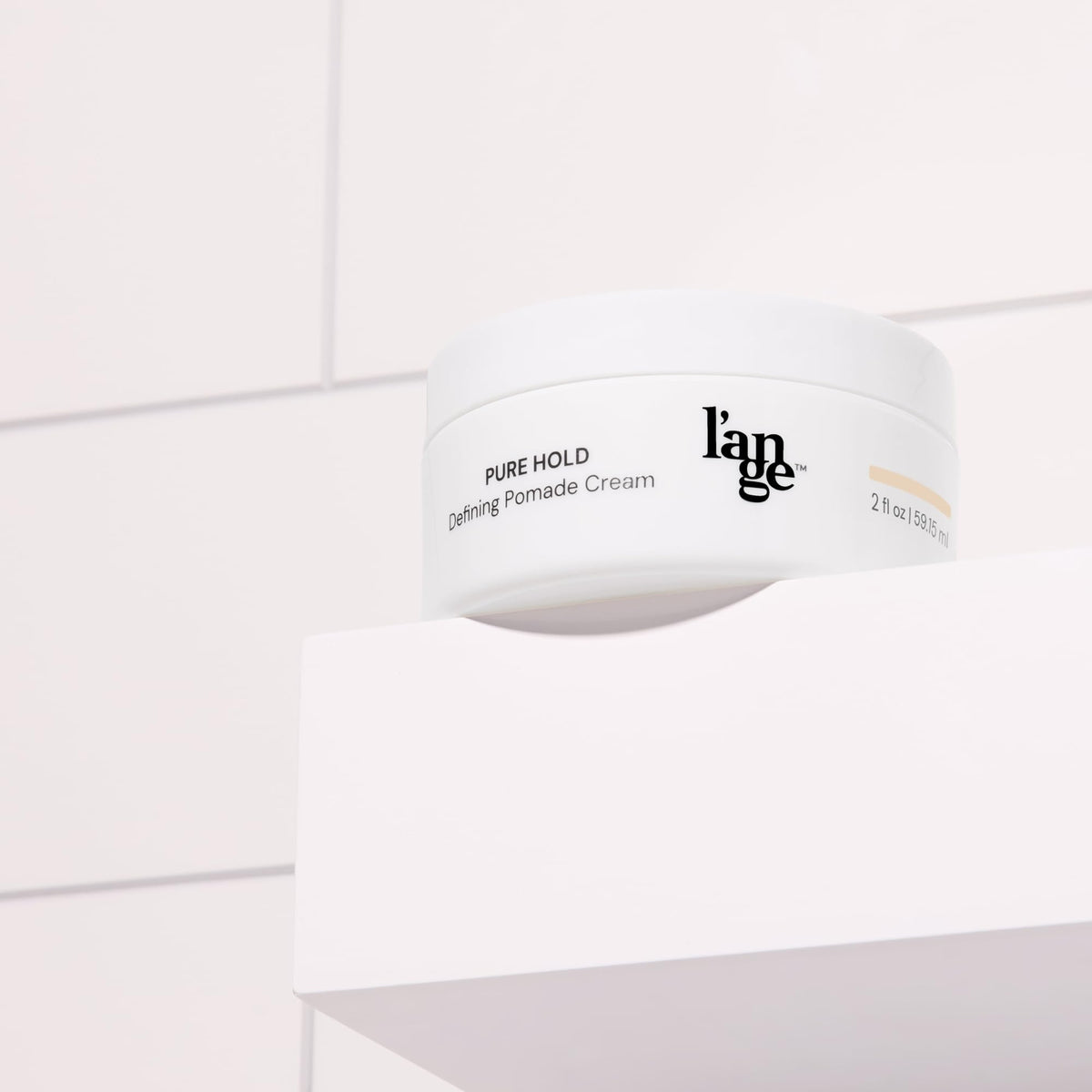 L'ANGE HAIR label close-up highlighting ingredients and easy-wash benefit