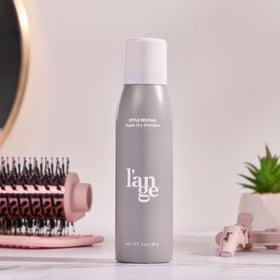 L'ANGE HAIR can on bathroom shelf beside styled hair showing refreshed volume and salon-safe scent