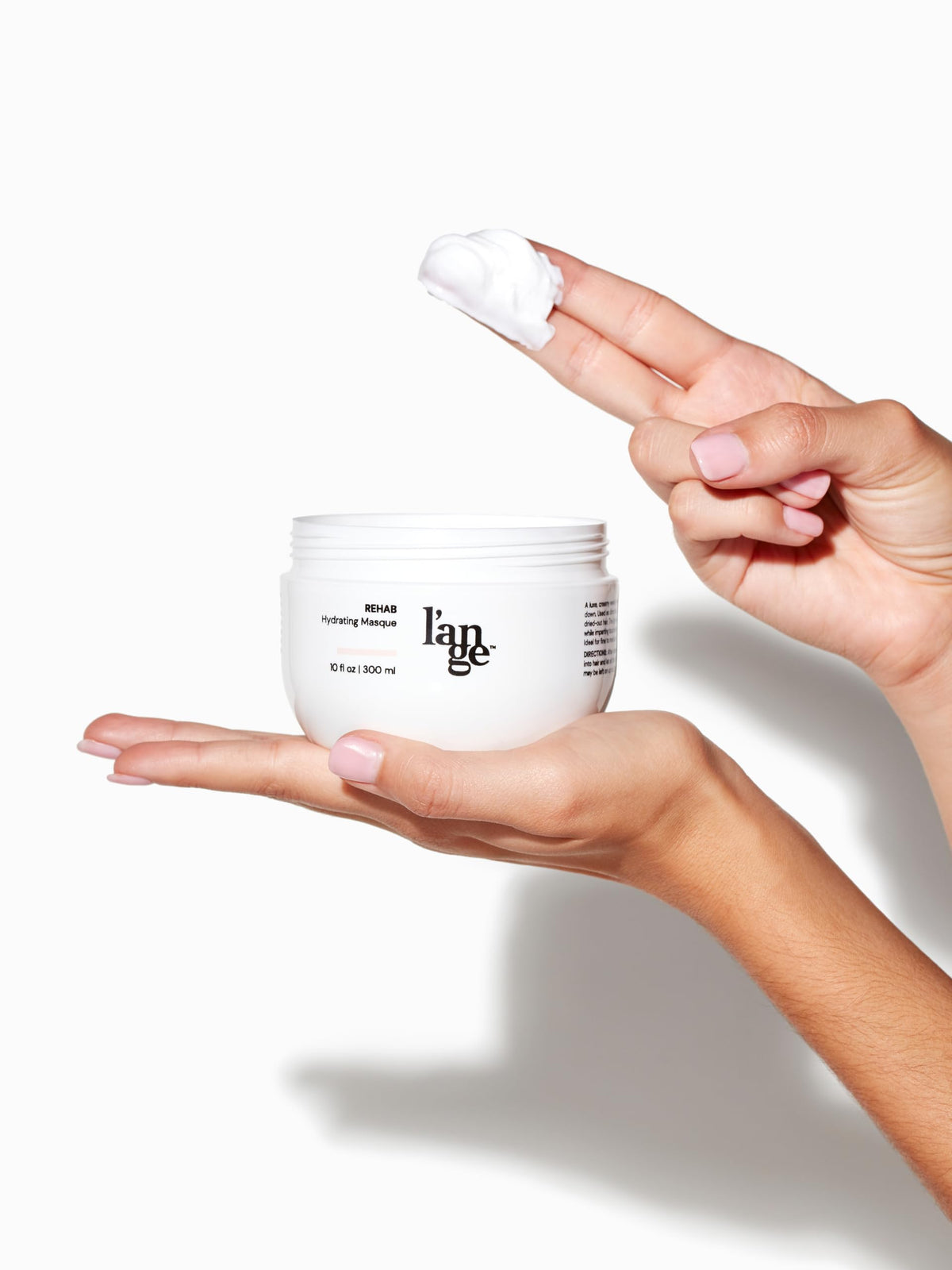 L'ANGE HAIR jar on bathroom shelf in lifestyle scene suggesting at-home salon benefit