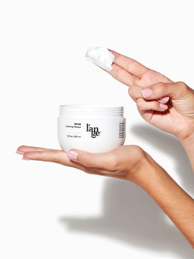 L'ANGE HAIR jar on bathroom shelf in lifestyle scene suggesting at-home salon benefit