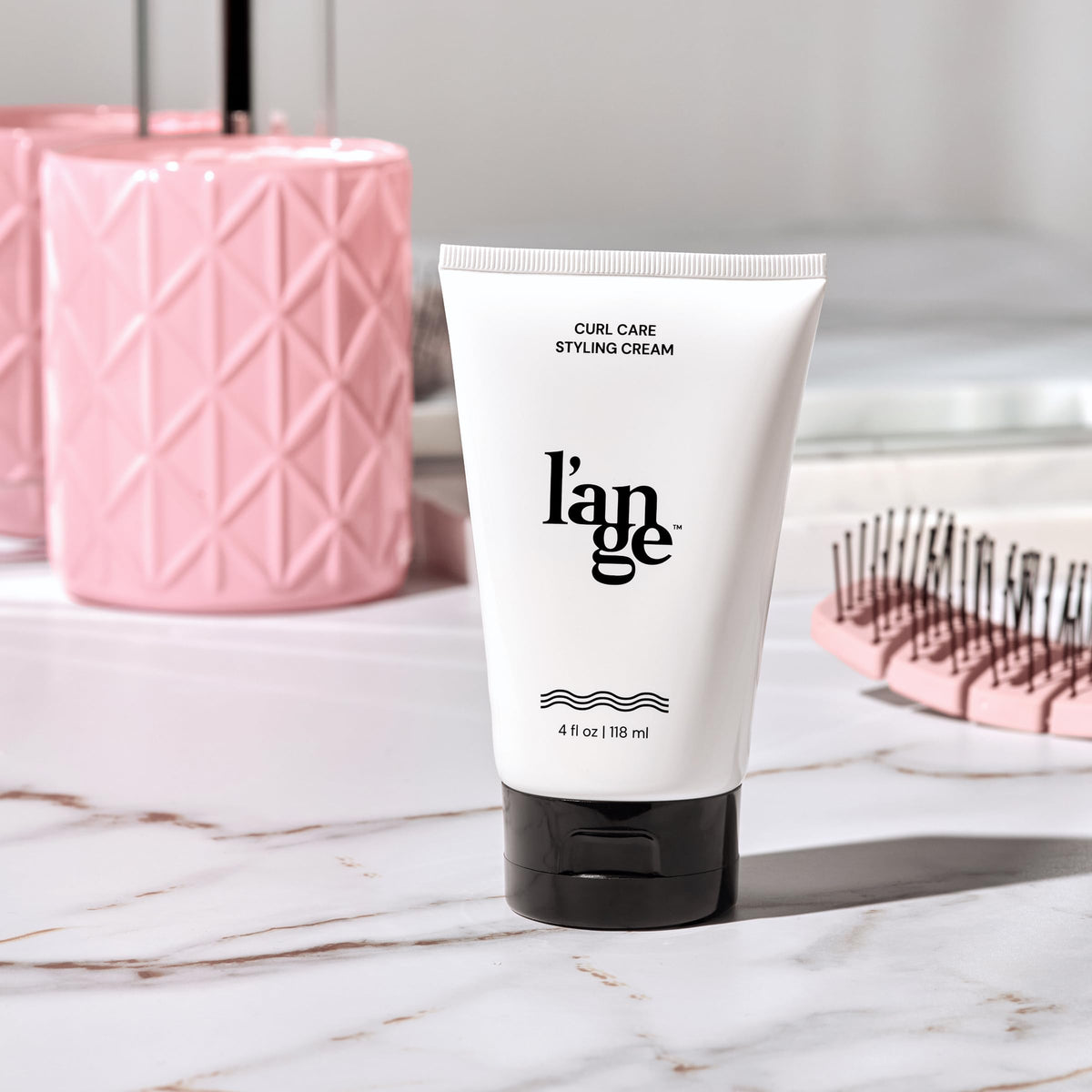 L'ANGE HAIR jar on vanity in bathroom scene showing everyday styling convenience