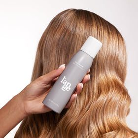 L'ANGE HAIR 3 oz can next to a credit card for scale illustrating portable size and on-the-go convenience