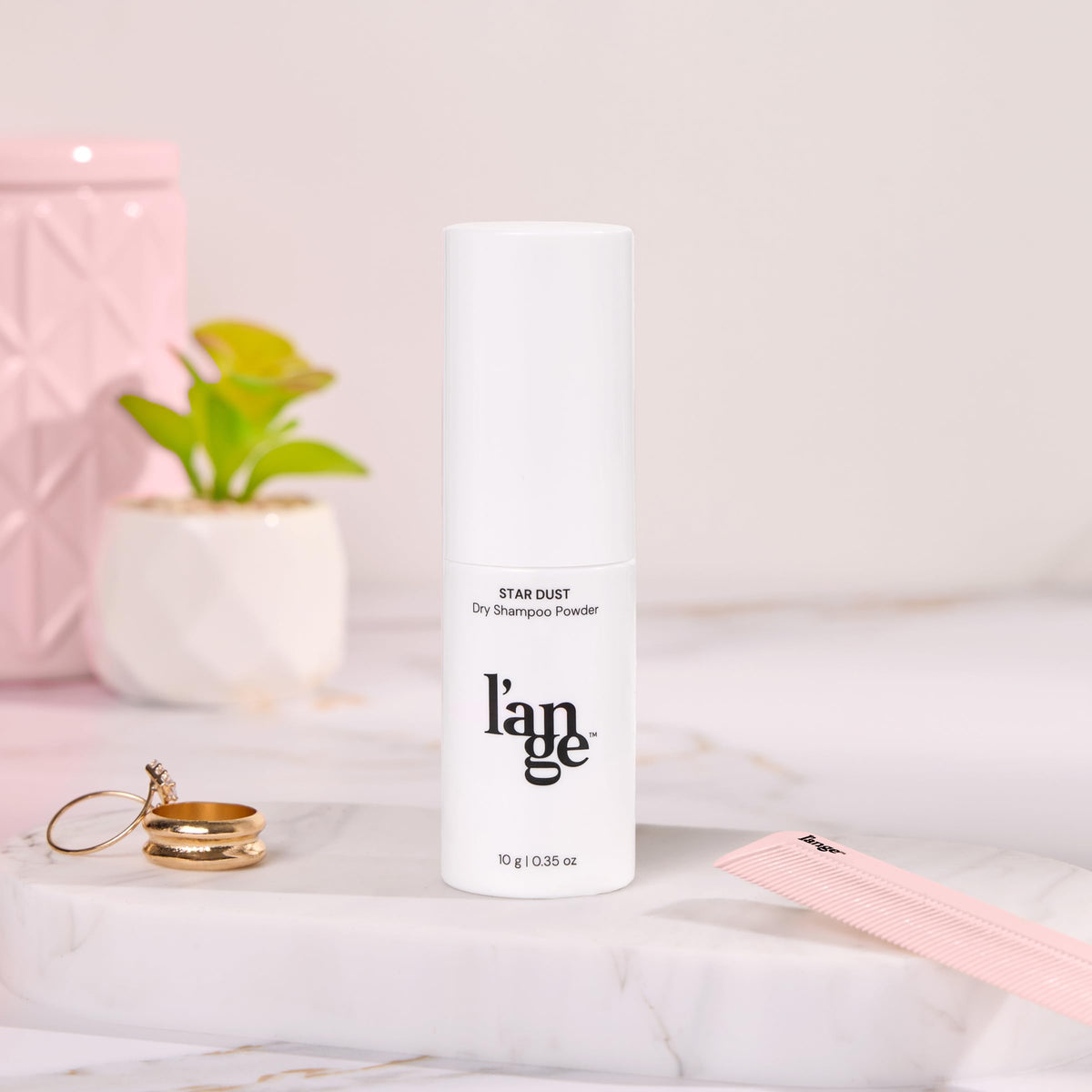 L'ANGE HAIR size comparison in hand showing compact travel size and easy storage