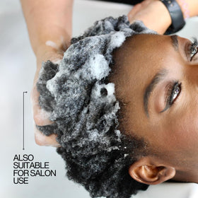 Lasio shampoo lather in hand demonstrating gentle, sulfate-free foam