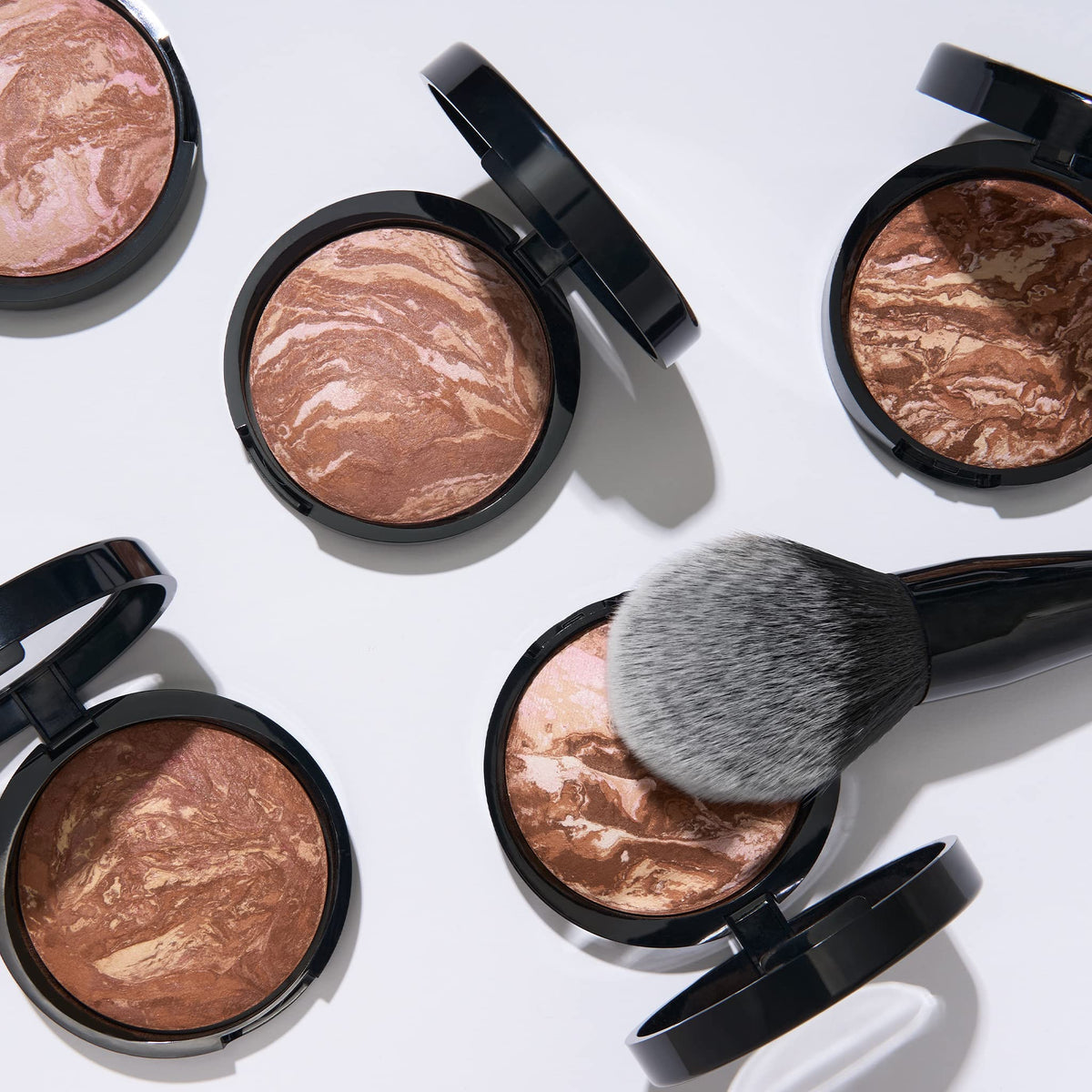 LAURA GELLER NEW YORK bronzer swept on collarbone for sun-kissed body warmth