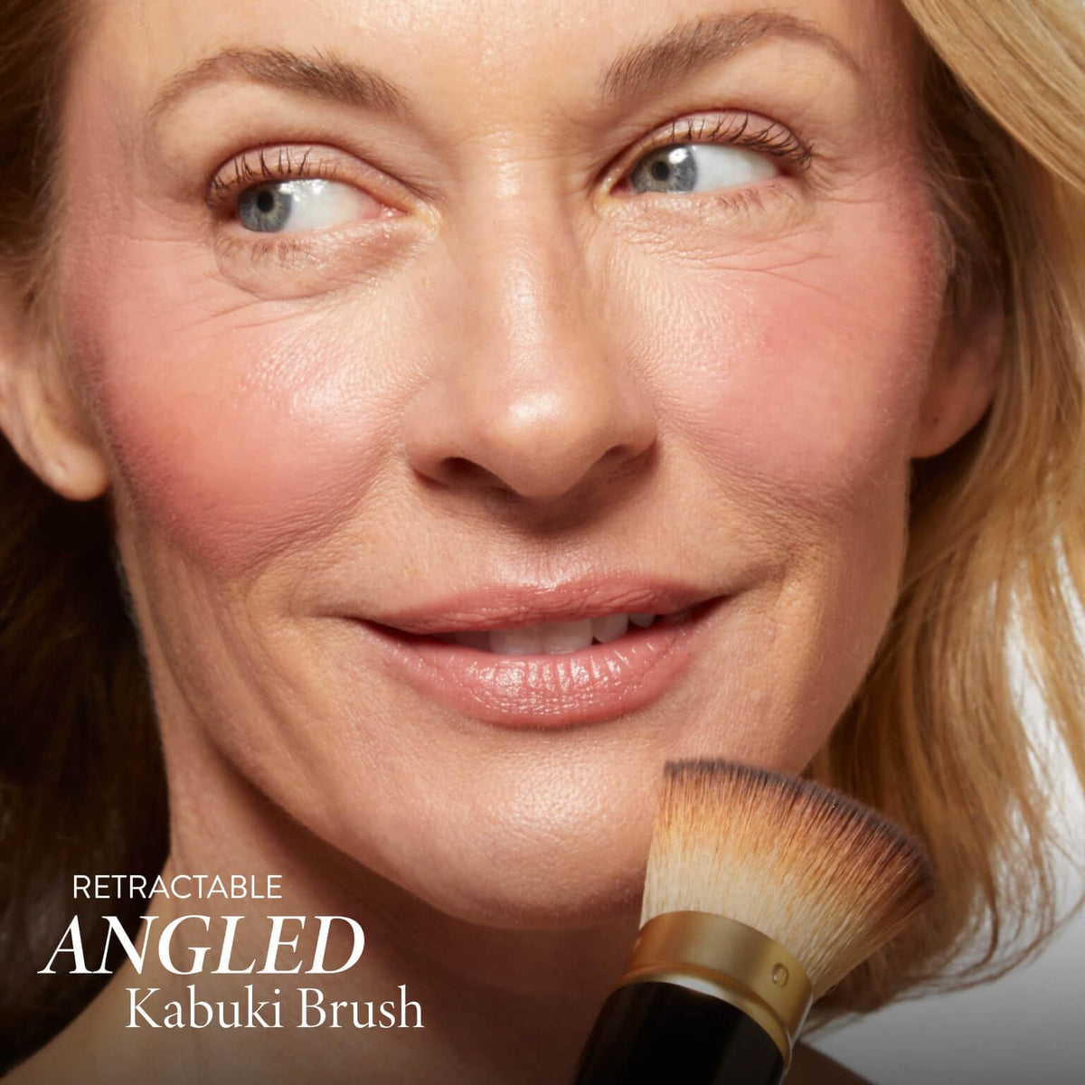 LAURA GELLER brush applying bronzer for natural contour and warmth