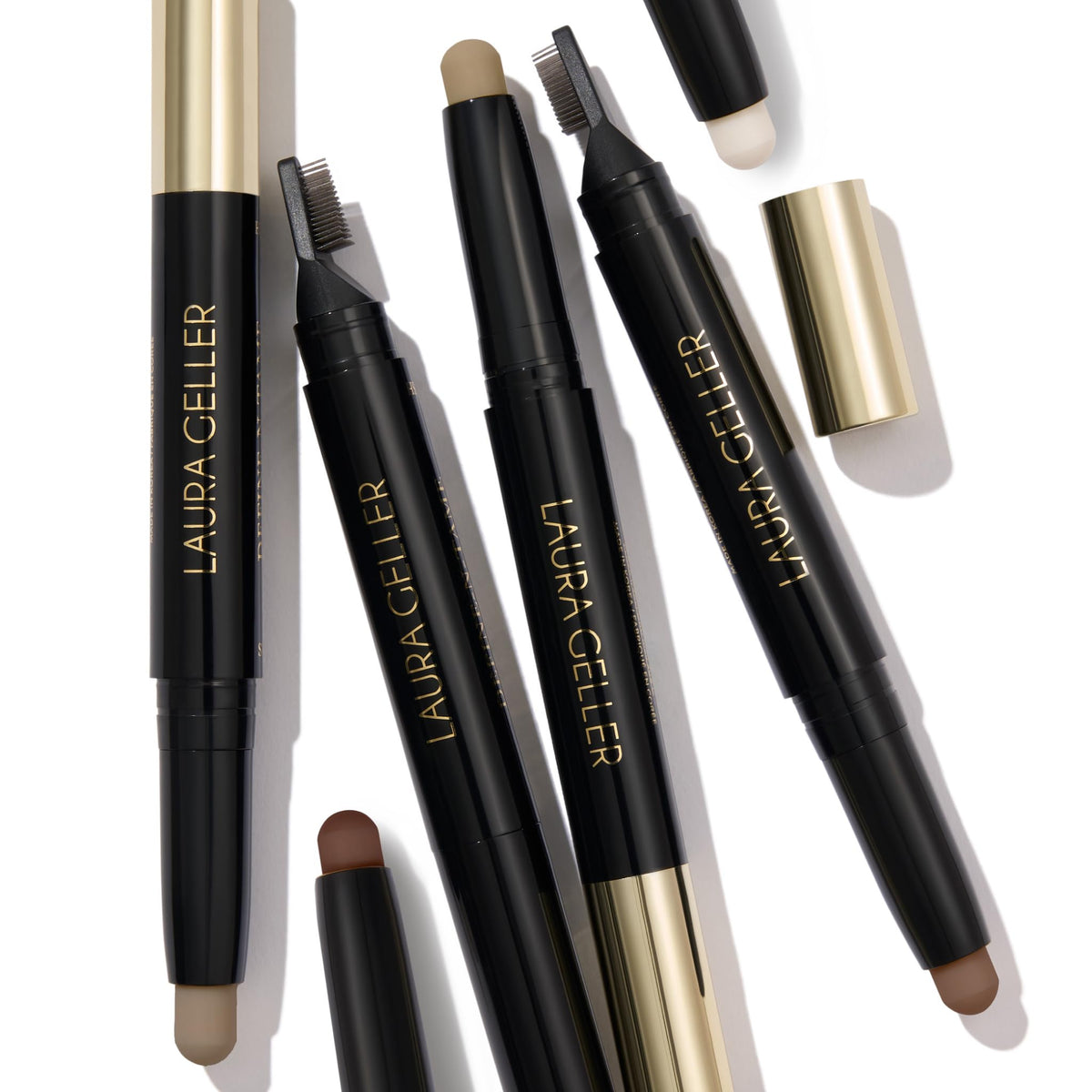 LAURA GELLER brow stick next to tools flatlay suggesting easy kit integration