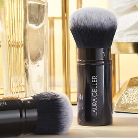 LAURA GELLER NEW YORK product held in hand showing travel-friendly size and portability
