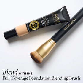 LAURA GELLER NEW YORK lifestyle scene of woman applying foundation at mirror