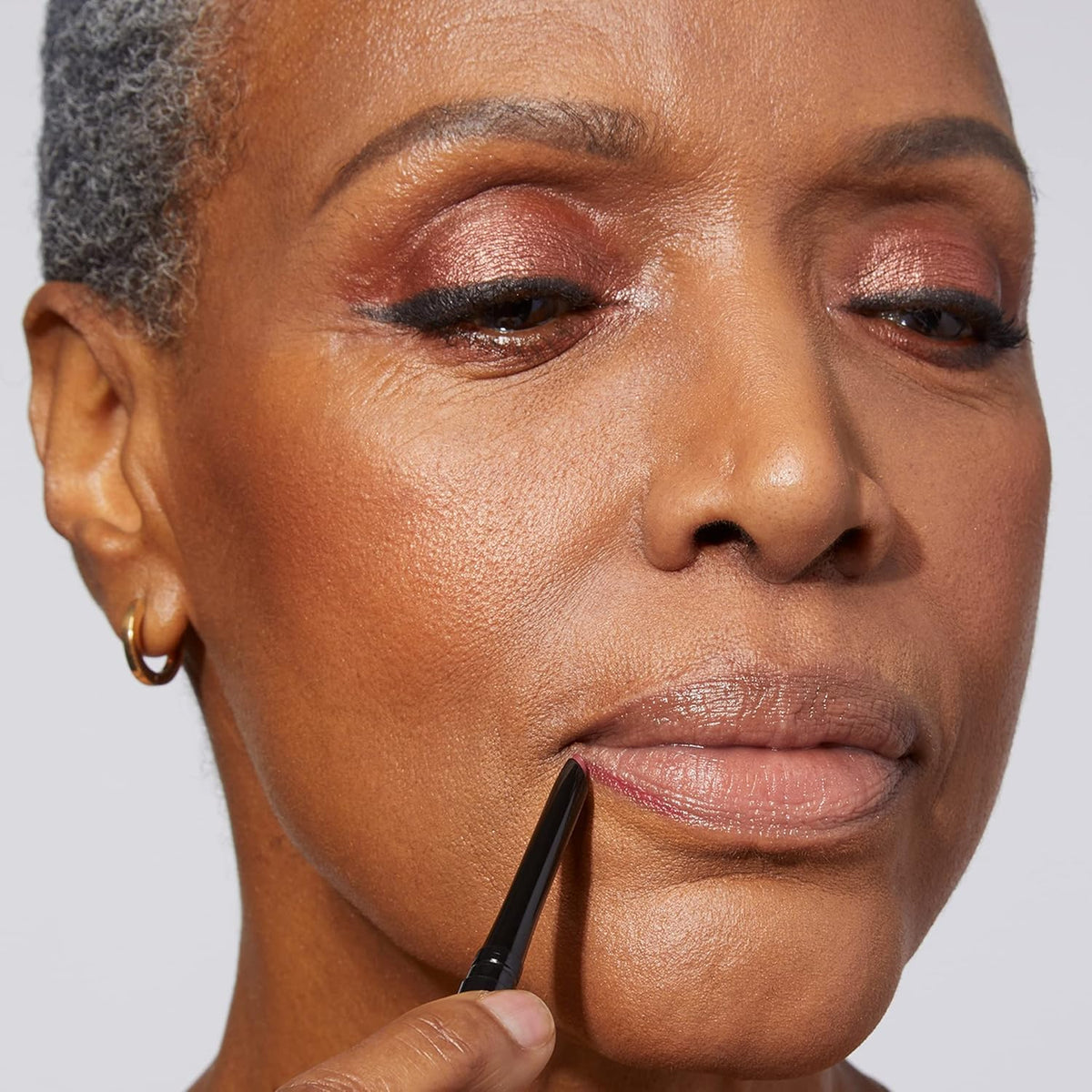LAURA GELLER NEW YORK lip liner on a vanity to show everyday use