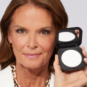 Laura Geller pressed powder texture detail showing fine-milled surface for even application