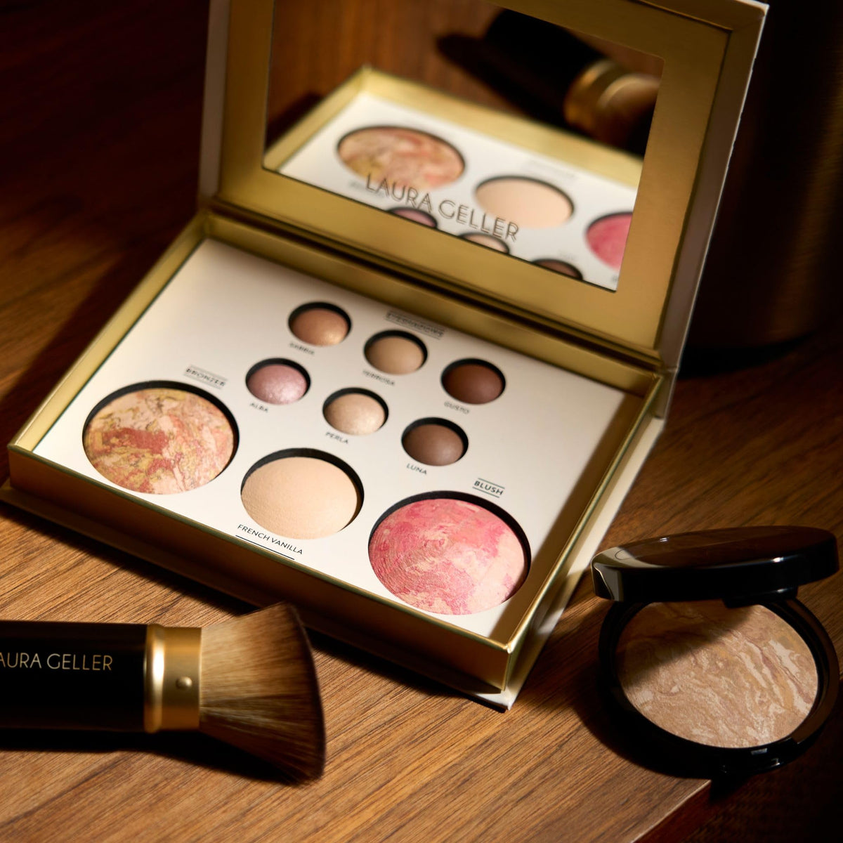 LAURA GELLER NEW YORK size scale with hand highlighting compact, travel-friendly dimensions