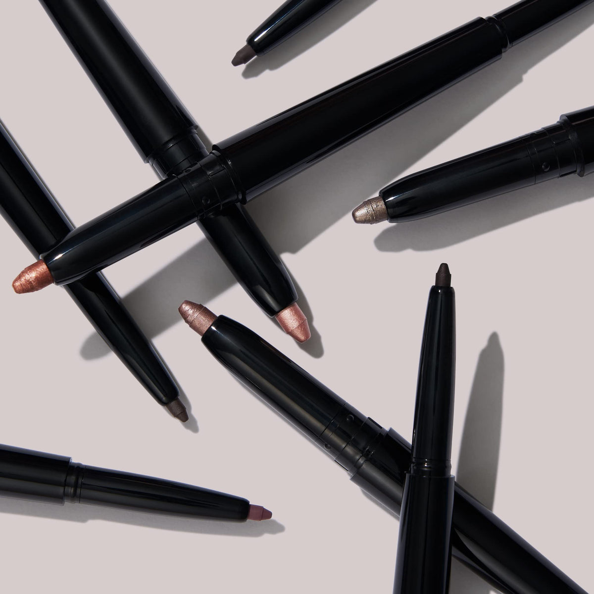 LAURA GELLER NEW YORK stick beside lipstick to show compact size and portability