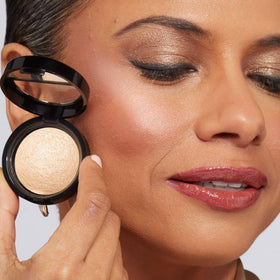 LAURA GELLER swatch on arm illustrating Portofino buildable champagne sheen