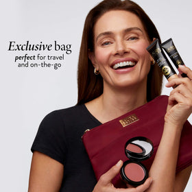 LAURA GELLER burgundy quilted cosmetic bag storing travel essentials