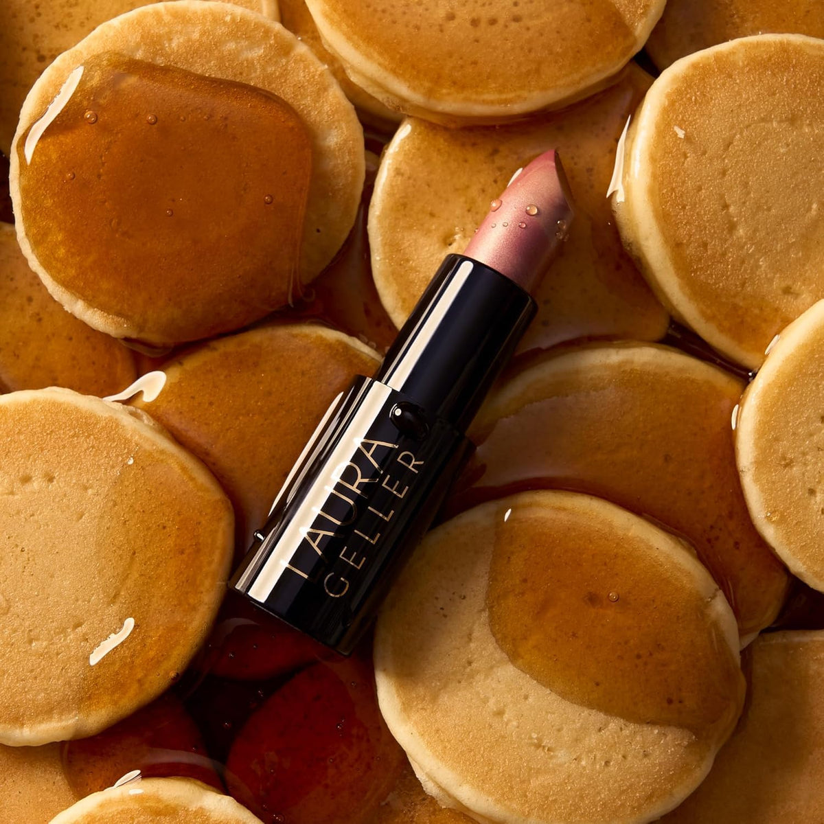 LAURA GELLER side angle of lipstick bullet showing cream formula and precise tip