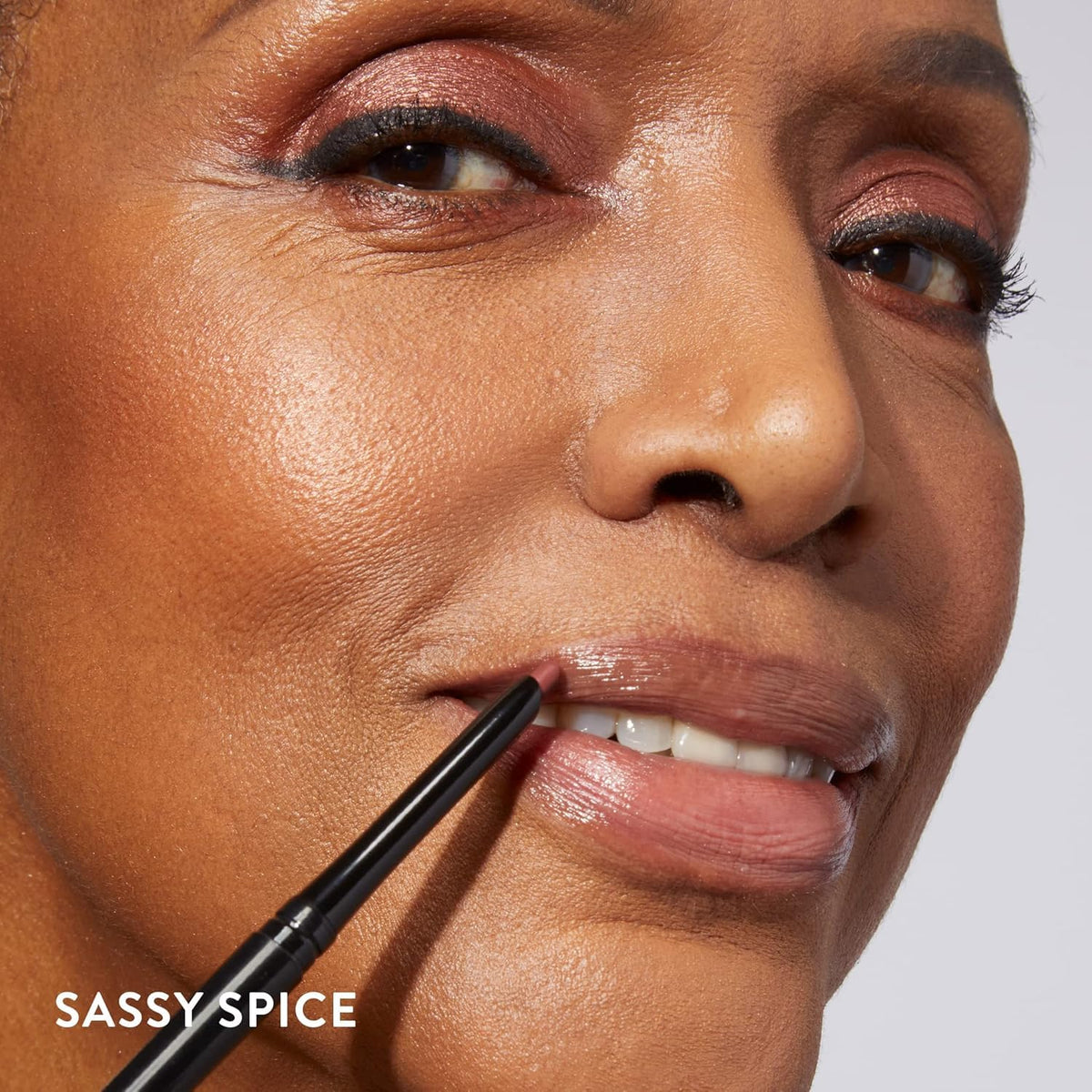 LAURA GELLER NEW YORK lip liner held in hand to show size and portability