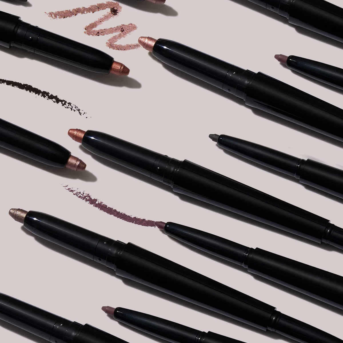 LAURA GELLER stick held in hand to show compact size and portability benefit