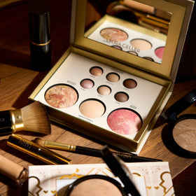 LAURA GELLER NEW YORK palette beside brush to show compact size for travel