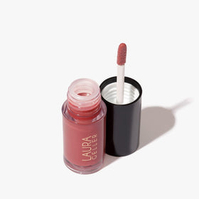 LAURA GELLER NEW YORK tube in hand illustrating size and portability for on-the-go touchups