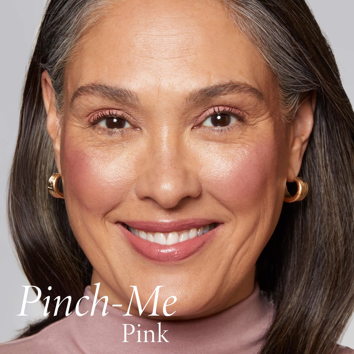 LAURA GELLER NEW YORK finger blending blush on cheek demonstrating seamless finish